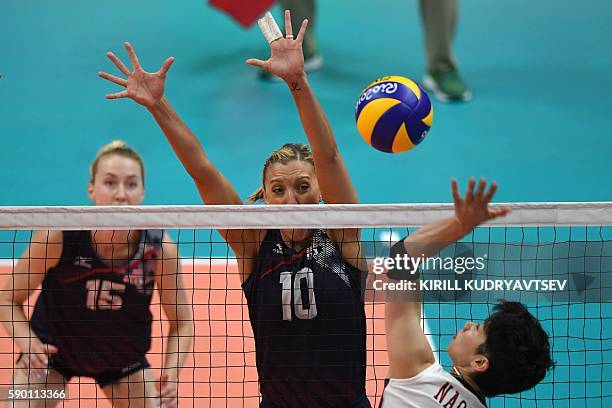 Japan's Miyu Nagaoka spikes the ball as USA's Jordan Larson-Burbach attempts to block during the women's quarter-final volleyball match between Japan...