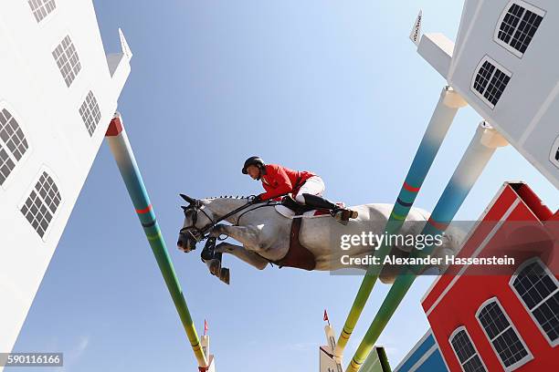 Martin Fuchs of Switzerland rides Clooney during the Team Jumping on Day 11 of the Rio 2016 Olympic Games at the Olympic Equestrian Centre on August...