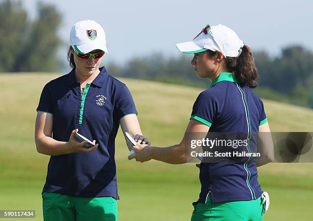 Sisters Lisa Maguire and Leona Maguire of Ireland look over a green during a practice round prior to the start of the women's golf during Day 11 of...