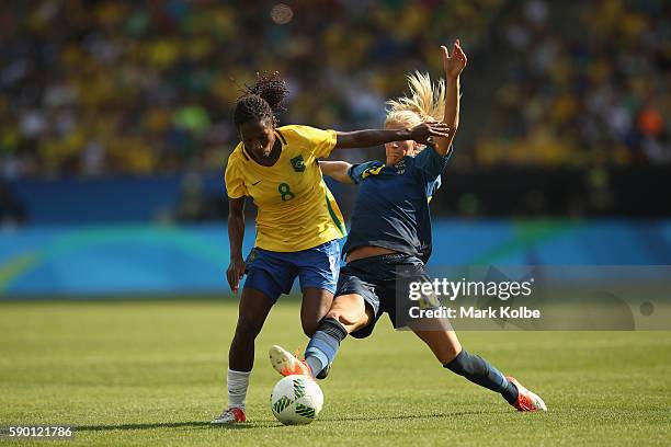 Formiga of Brazil and Sofia Jakobsson of Sweden compete for the ball during the Women's Football Semi Final between Brazil and Sweden on Day 11 of...