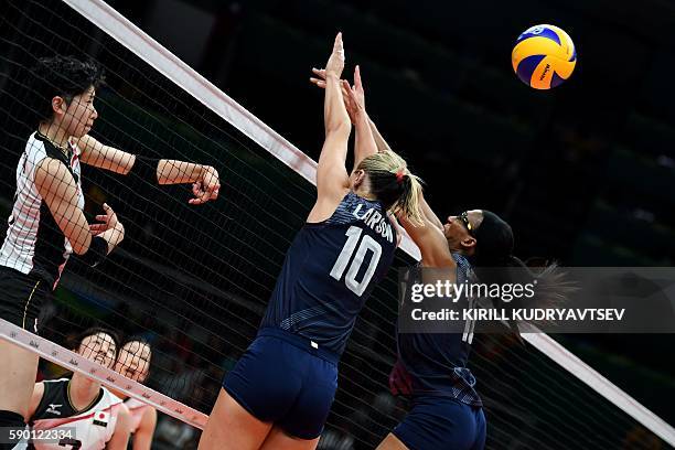 Japan's Miyu Nagaoka spikes the ball as USA's Jordan Larson-Burbach and USA's Foluke Akinradewo attempt to block during the women's quarter-final...