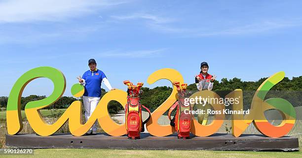 Shanshan Feng and Xi Yu Lin of China pose with the Rio 2016 sign during a practice round prior to the Women's Individual Stroke Play golf at the...