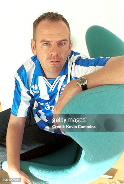 English DJ and record producer, Fat Boy Slim wearing a Brighton And Hove Albion football shirt, circa 2000.