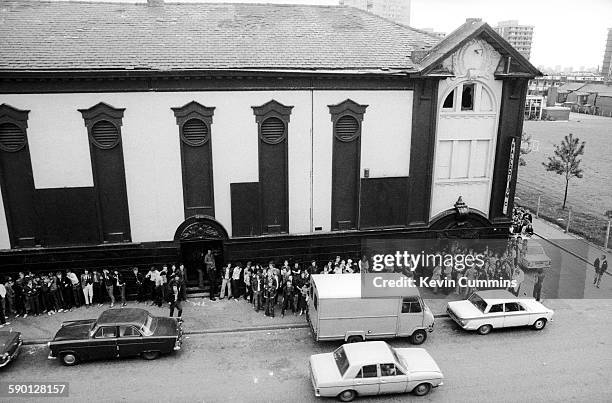 Fans queuing outside the Electric Circus music venue, formerly the Palladium cinema, in, Collyhurst, Manchester, 29th May 1977. On the bill are...