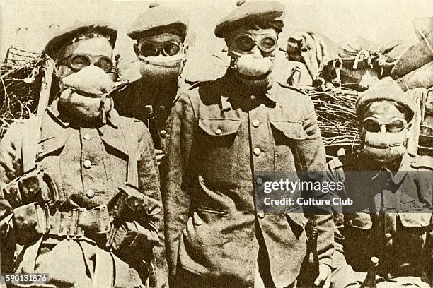 Soldiers wearing an early type of gas mask after the introduction of chemical warfare, First World War, 1915. Cotton wool pad soaked in washing-soda...