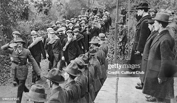 Eamon de Valera , Irish politician, receiving the salute of members of Sinn Fein marching past, 1919