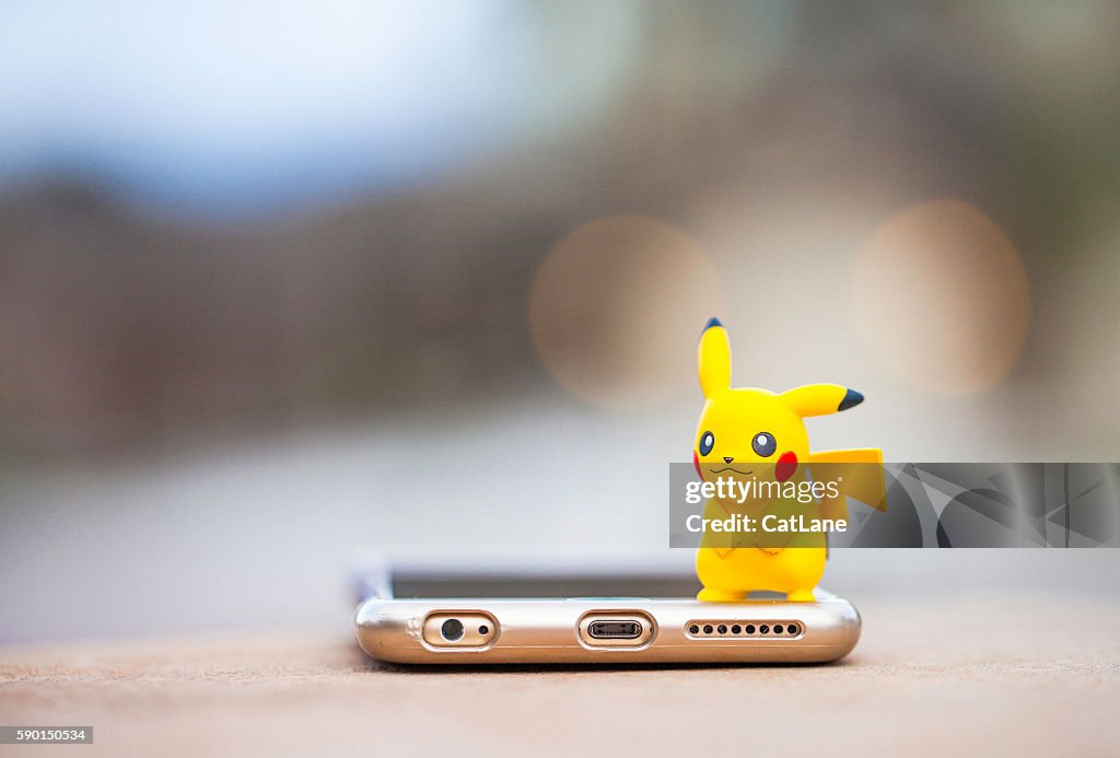 Nintendo Pokemon Go character Pikachu and iPhone
