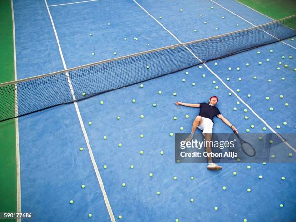 male tennis player lying on ground - large group of objects sport stock pictures, royalty-free photos & images