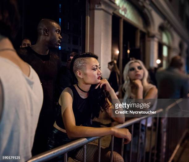 standing in line for the club - woman waiting in line stock pictures, royalty-free photos & images