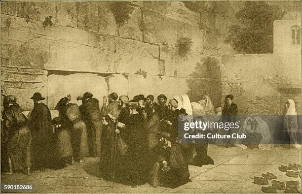 Group of men and women praying at the Western Wall / Wailing Wall in the Old City of Jerusalem. Remnant of the ancient wall that surrounded the...