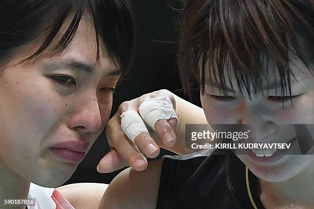 Japan's Saori Sakoda and Saori Kimura react after losing the women's quarter-final volleyball match between Japan and USA at the Maracanazinho...