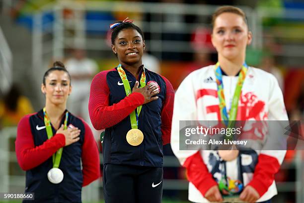 Silver medalist Alexandra Raisman of the United States, gold medalist Simone Biles of the United States and Amy Tinkler of Great Britain stand for...