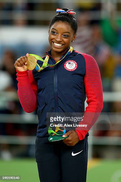 Gold medalist Simone Biles of the United States celebrates on the podium at the medal ceremony for the Women's Floor on Day 11 of the Rio 2016...