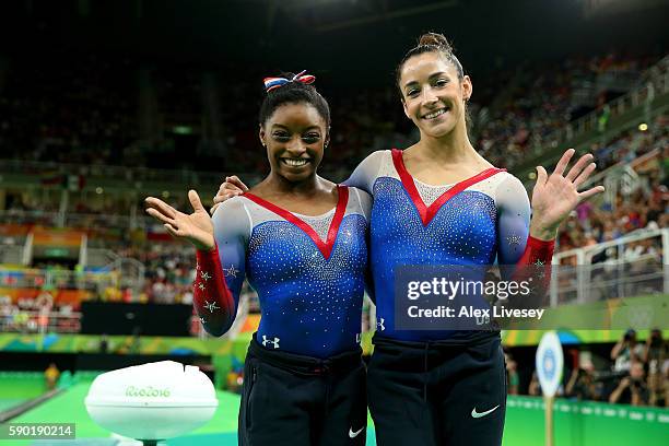 Simone Biles and Alexandra Raisman of the United States pose for photographs after winning the gold and silver medals respectively after competing on...