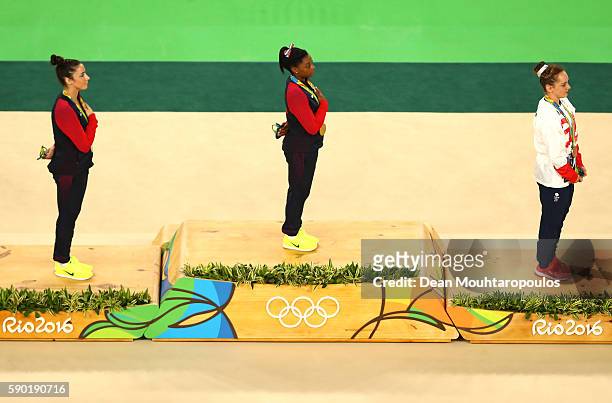 Silver medalist Alexandra Raisman of the United States, gold medalist Simone Biles of the United States and bronze medalist Amy Tinkler of Great...