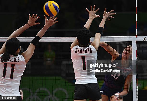 Jordan Larson-Burbach of The United States opikes the ball past Miyu Nagaoka and Erika Araki of Japan during the Women's Quarterfinal match between...