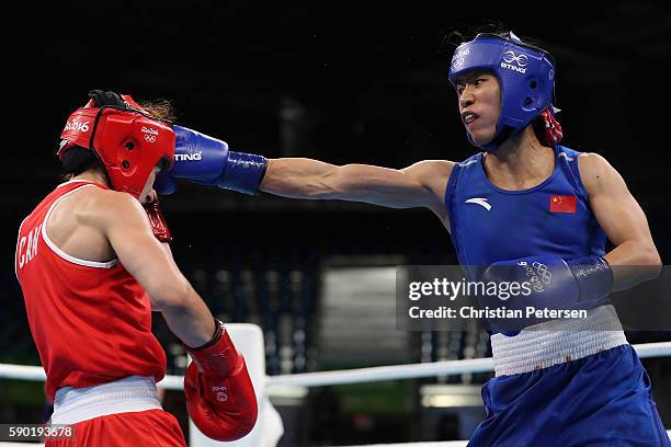 Cancan Ren of China throws a right on Mandy Bujold of Canada in the boxing Women's Fly Quarterfinal 2 on Day 11 of the Rio 2016 Olympic Games at...