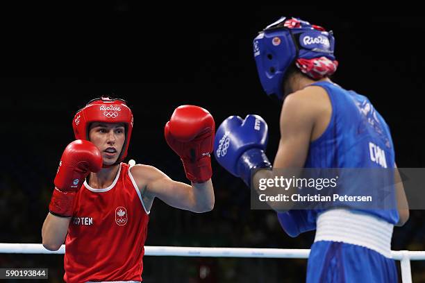 Mandy Bujold of Canada firghts Cancan Ren of China in the boxing Women's Fly Quarterfinal 2 on Day 11 of the Rio 2016 Olympic Games at Riocentro on...