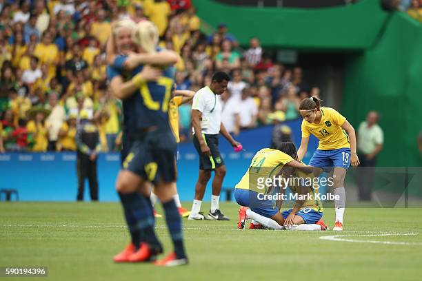 Marta of Brazil goes to ground looking dejected following the Women's Football Semi Final between Brazil and Sweden on Day 11 of the Rio 2016 Olympic...