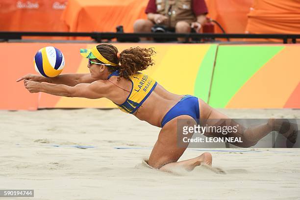 Brazil's Larissa Franca Maestrini dives for the ball during the women's beach volleyball semi-final match between Brazil and Germany at the Beach...