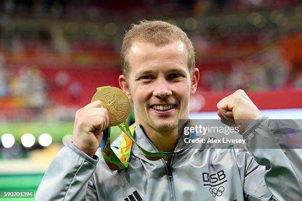 Gold medalist Fabian Hambuechen of Germany poses for photographs after the at the medal ceremony for the Horizontal Bar Final on Day 11 of the Rio...