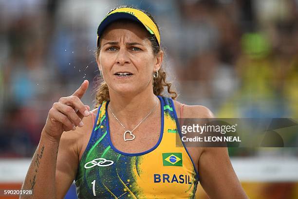 Brazil's Larissa Franca Maestrini flicks sweat from her finger during the women's beach volleyball semi-final match between Brazil and Germany at the...