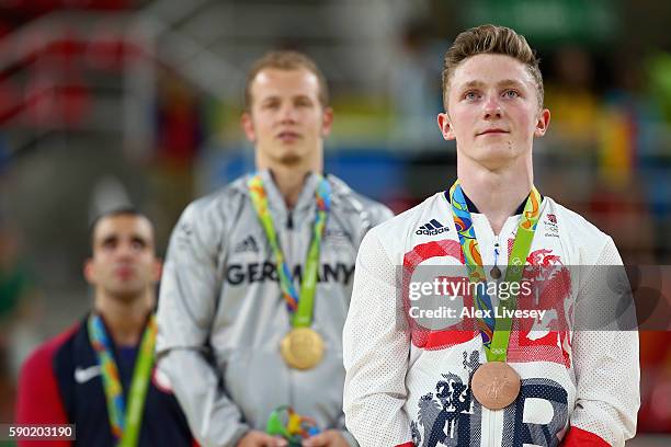 Silver medalist Danell Leyva of the United States, gold medalist Fabian Hambuechen of Germany and bronze medalist Nile Wilson of Great Britain pose...