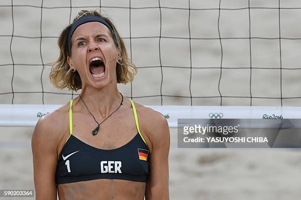 Germany's Laura Ludwig reacts during the women's beach volleyball semi-final match between Brazil and Germany at the Beach Volley Arena in Rio de...