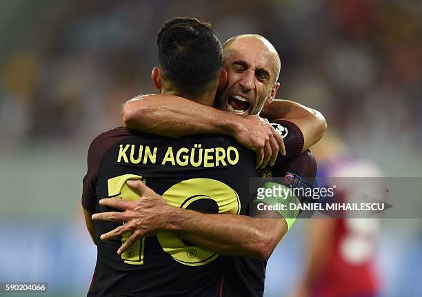 Manchester City's Argentinian striker Sergio Aguero celebrates with Manchester City's Argentinian defender Pablo Zabaleta after scoring a goal during...