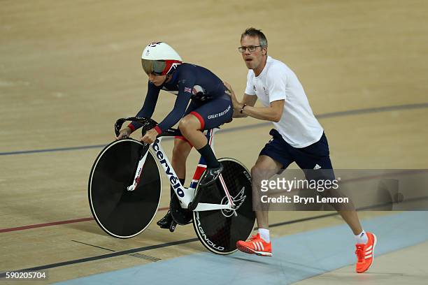 Laura Trott of Great Britain gets a start from coach Paul Manning during the Women's Omnium Flying Lap 5\6 race on Day 11 of the Rio 2016 Olympic...