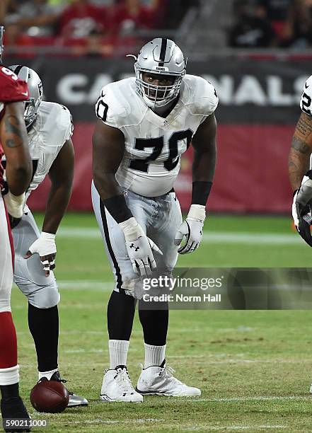 Kelechi Osemele of the Oakland Raiders listens for an audible while standing at the line of scrimmage against the Arizona Cardinals at University of...