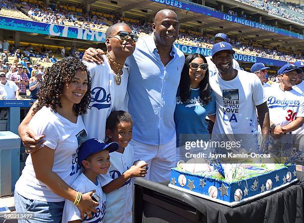 Former NBA great Magic Johnson celebrates his birthday with his family before the game between the Los Angeles Dodgers and the Pittsburgh Pirates at...