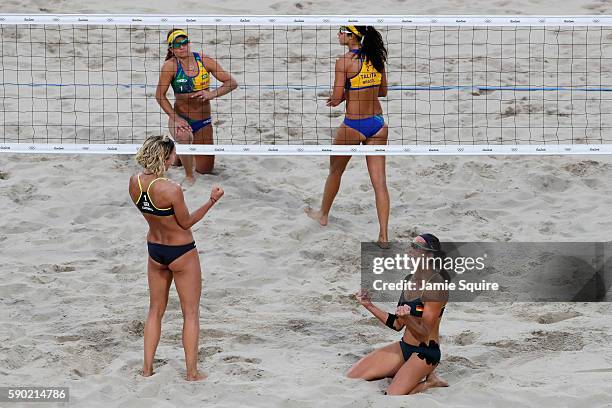 Laura Ludwig and Kira Walkenhorst of Germany celebrate beating Larissa Franca Maestrini and Talita Rocha of Brazil during the beach volleyball...