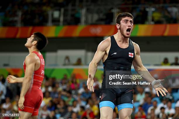 Shmagi Bolkvadze of Georgia celebrates winning Bronze against Tomohiro Inoue of Japan in the Men's Greco-Roman 66 kg Bronze Medal bout on Day 11 of...