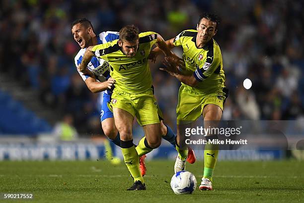 Stephen Kelly of Rotherham United elbows Tomer Hemed of Brighton and Hove Albion as Joe Mattock of Rotherham United attempts to tackle during the Sky...