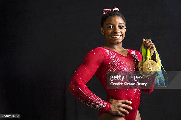 Summer Olympics: Portrait of Team USA gymnast Simone Biles posing with 4 Gold medals and 1 Bronze medal during photo shoot at Main Press Centre in...
