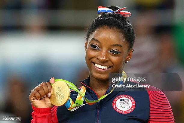 Gold medalist Simone Biles of the United States celebrates on the podium at the medal ceremony for the Women's Floor on Day 11 of the Rio 2016...