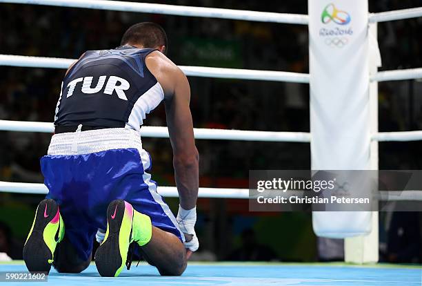 Batuhan Gozgec of Turkey reacts after being defeated by Artem Harutyunyan of Germany in the Men's Light Welter Quarterfinal 3 on Day 11 of the Rio...