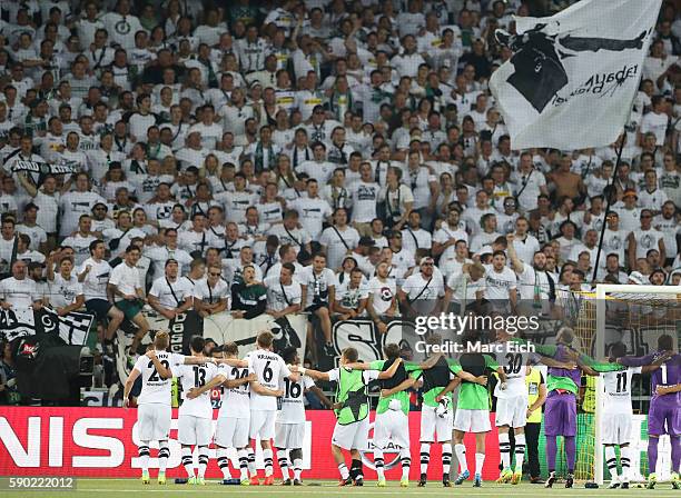 The team of Borussia Moenchengladbach celebrates the victory with fans after the Champions League Playoff match between Young Boys Bern and Borussia...