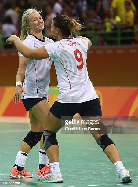 Stine Bredal Oftedal of Norway celebrates with Nora Mork of Norway after winning the Womens Quarterfinal match between Sweden and Norway on Day 11 of...