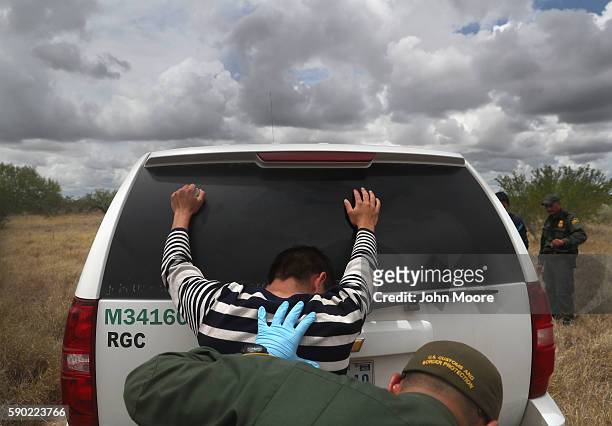 Detained immigrants are searched after being captured by U.S. Border Patrol agents on August 16, 2016 in Roma, Texas. Border security has become a...