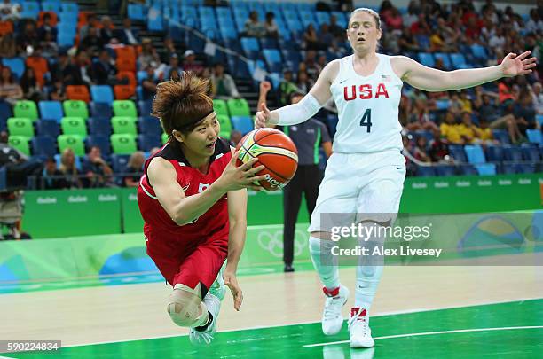 Maki Takada of Japan dives to save the ball as Lindsay Whalen of United States looks on during the Women's Quarterfinal match on Day 11 of the Rio...