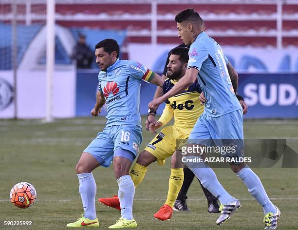 Bolivia's Bolivar Walter Flores and Nelson Cabrera vie for the ball with Jean Meneses of Chile' U. Concepcion during their first-round 2016 Copa...