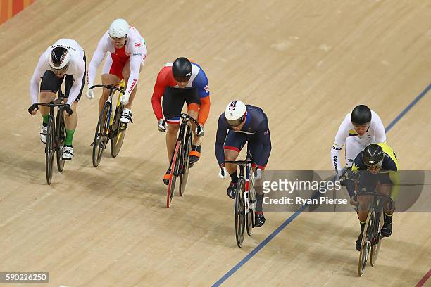 Jason Kenny of Great Britain, Matthijs Buchli of the Netherlands and Azizulhasni Awang of Malaysia compete during the Men's Keirin Finals race on Day...