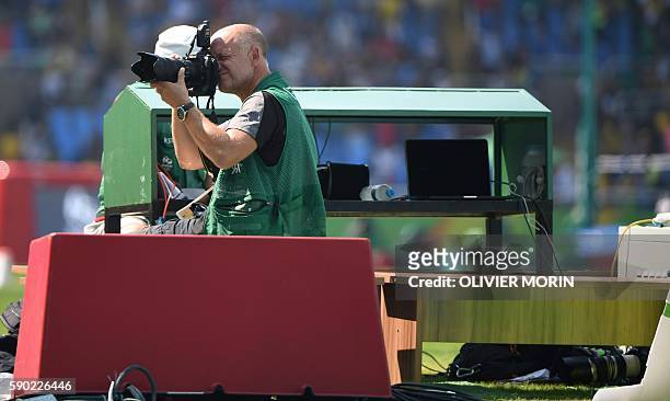 Photographer Franck Fife is seen at work at the Olympic stadium of the Rio 2016 Olympic games on August 16, 2016 in Rio de Janeiro. An AFP team of...
