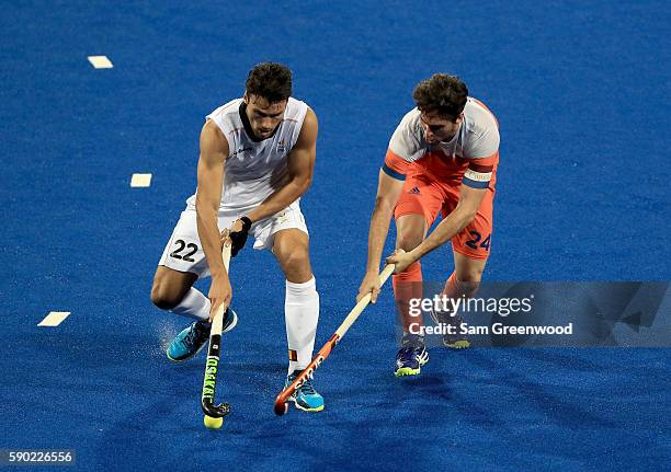 Simon Gougnard of Belgium and Robert Van der Horst of the Netherlands battle for a loose ball during a semifinal match on Day 11 of the Rio 2016...