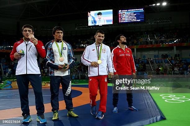 Silver medalist Migran Arutyunyan of Armenia, gold medalist Davor Stefanek of Serbia and bronze medalists Shmagi Bolkvadze of Georgia and Rasul...