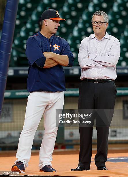 Manager A.J. Hinch of the Houston Astros, left, and general manager Jeff Luhnow talk during batting practice before playing the St. Louis Cardinals...