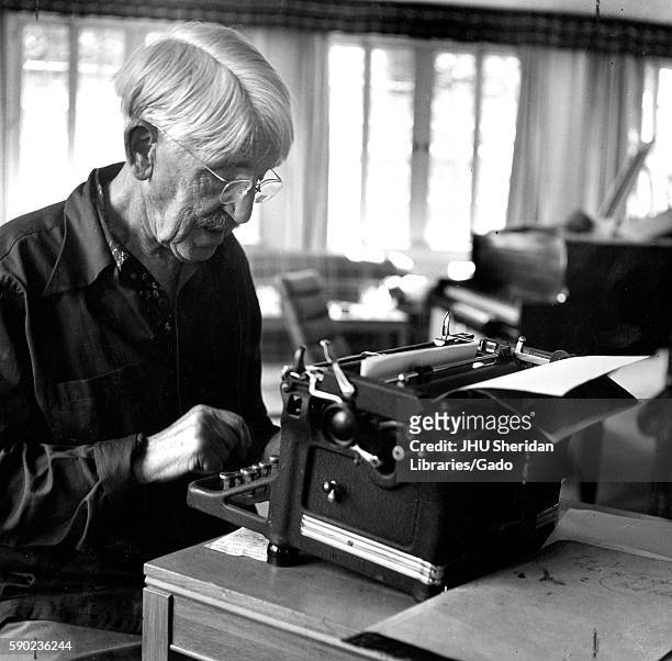 Candid portrait of American philosopher, psychologist, and educational reformer John Dewey sitting at a typewriter, 1946. .