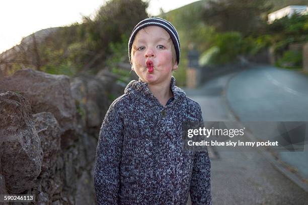 a young boy making a face like a fish - llandudno stock pictures, royalty-free photos & images